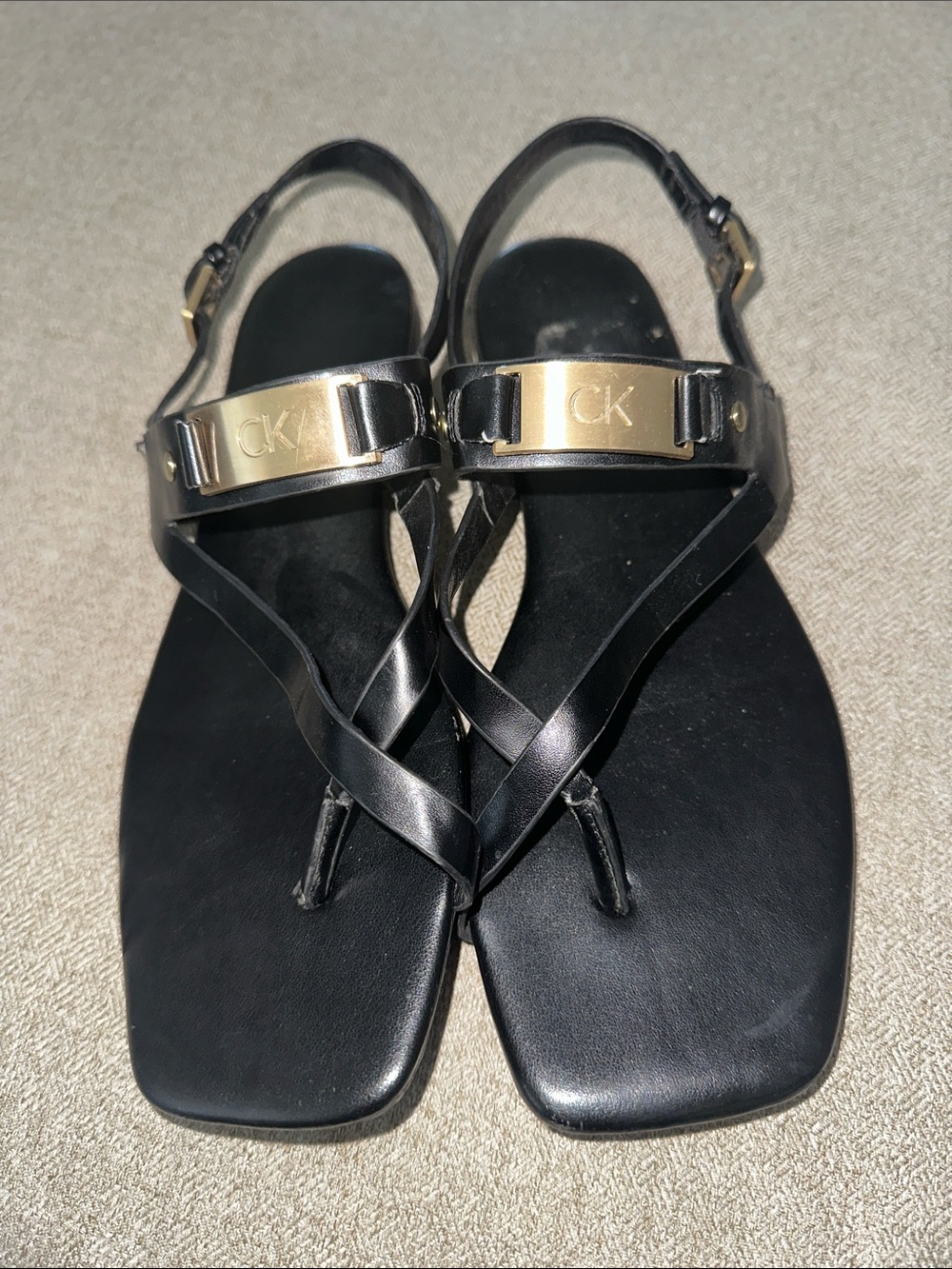 Calvin Klein Black Leather T-Strap Sandals with Gold Plaque
